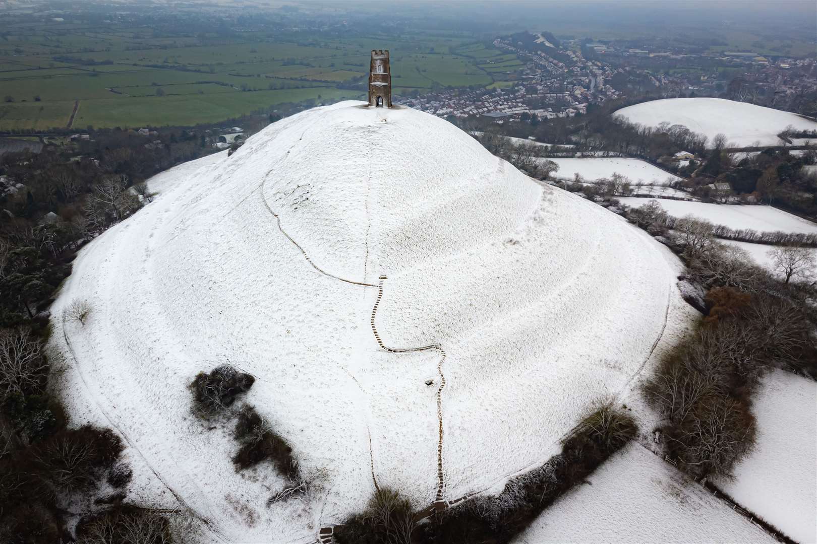 Snow settles on Glastonbury Tor (Ben Birchall/PA)
