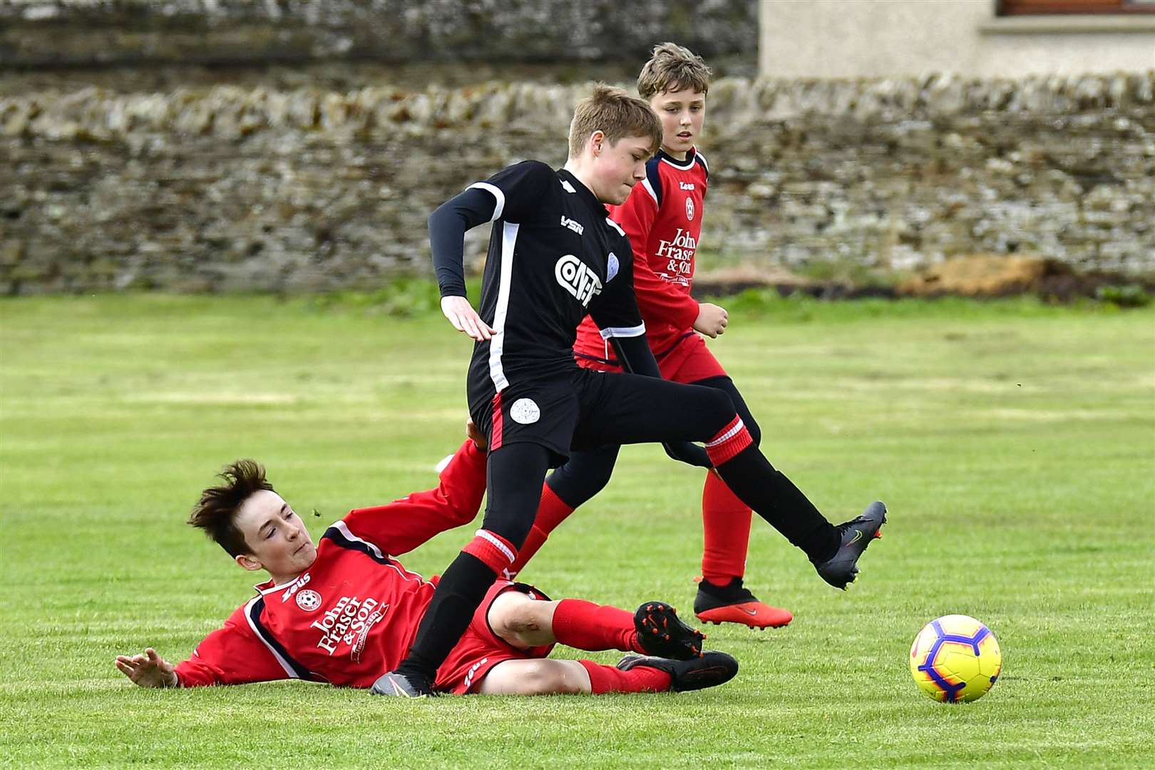 Caithness United's Sam Reid evades a challenge from a Balloan defender. Picture: Mel Roger