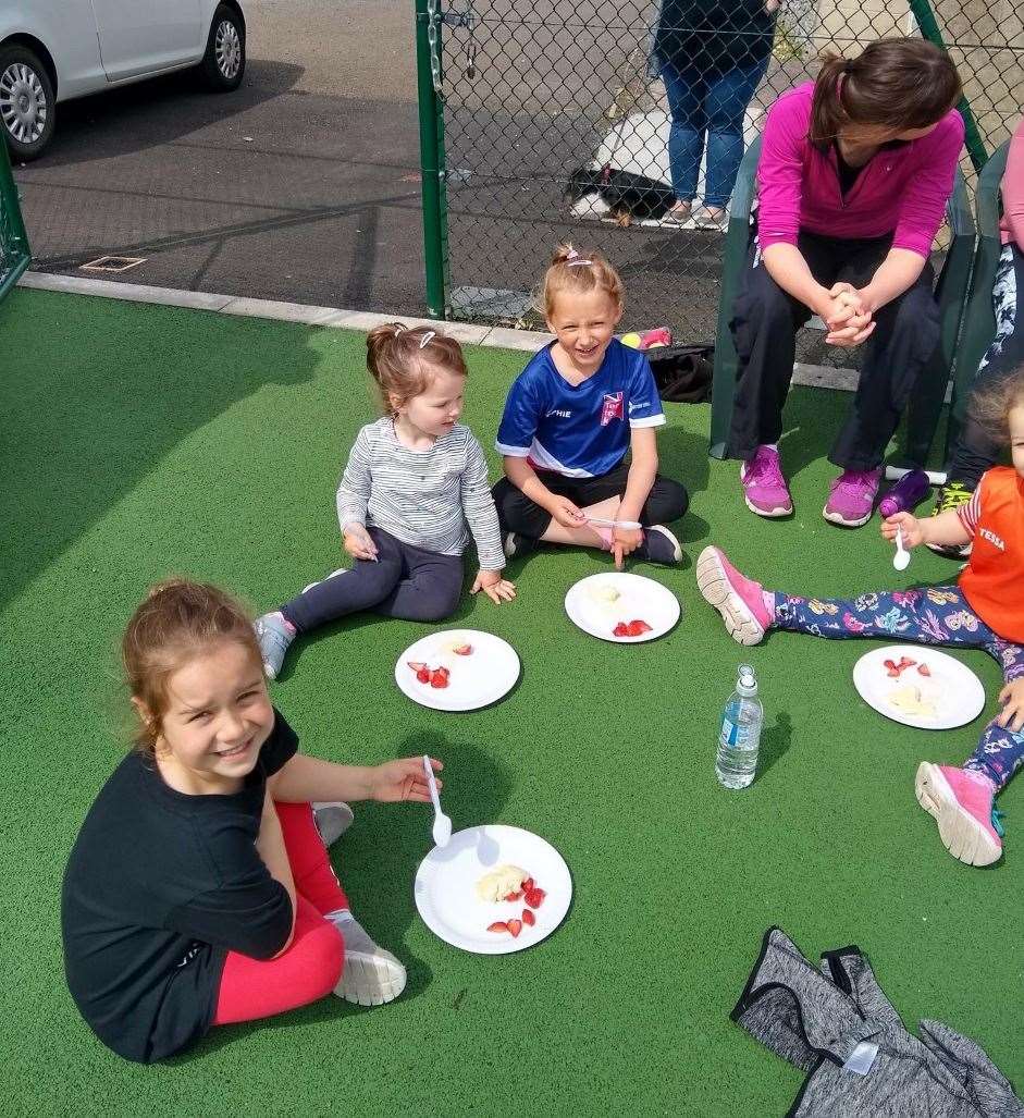 Wimbledon-style strawberries and ice cream for these youngsters.