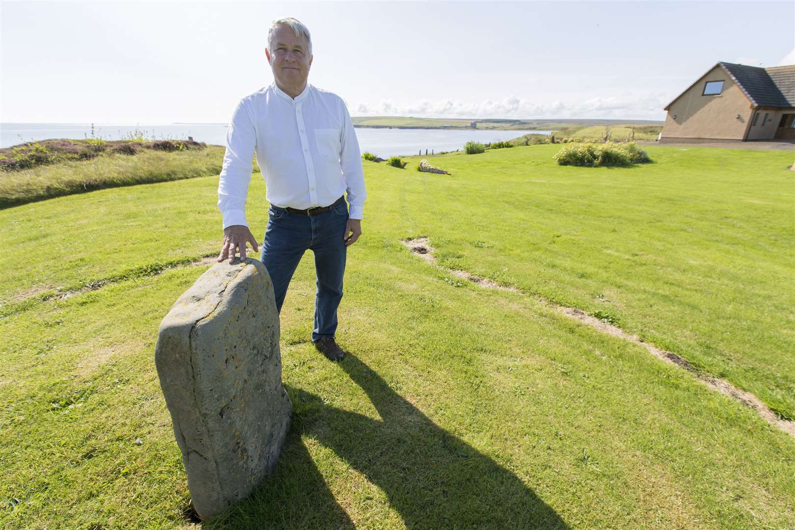 Neil MacCallum, Lathabreck, Skirza, with the standing stone in his memorial garden in memory of Queen Elizabeth II. Photo: Robert MacDonald/Northern Studios