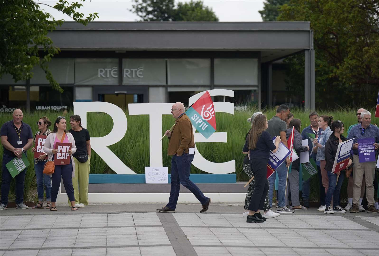 Members of staff from RTE take part in a protest at the broadcaster’s headquarters in Donnybrook (Niall Carson/PA)