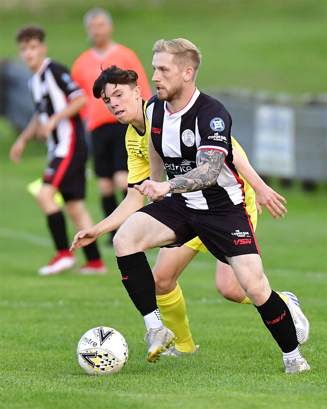 Alan Hughes of Wick Academy goes past Clach's Robbie Thompson during the 1-0 win on Wednesday. Picture: Mel Roger