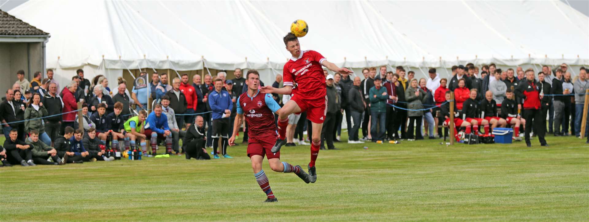Conor Farquhar (Wick Groats) wins the ball from Allan Munro (Pentland United) during the Eain Mackintosh Cup final at Halkirk. Picture: James Gunn