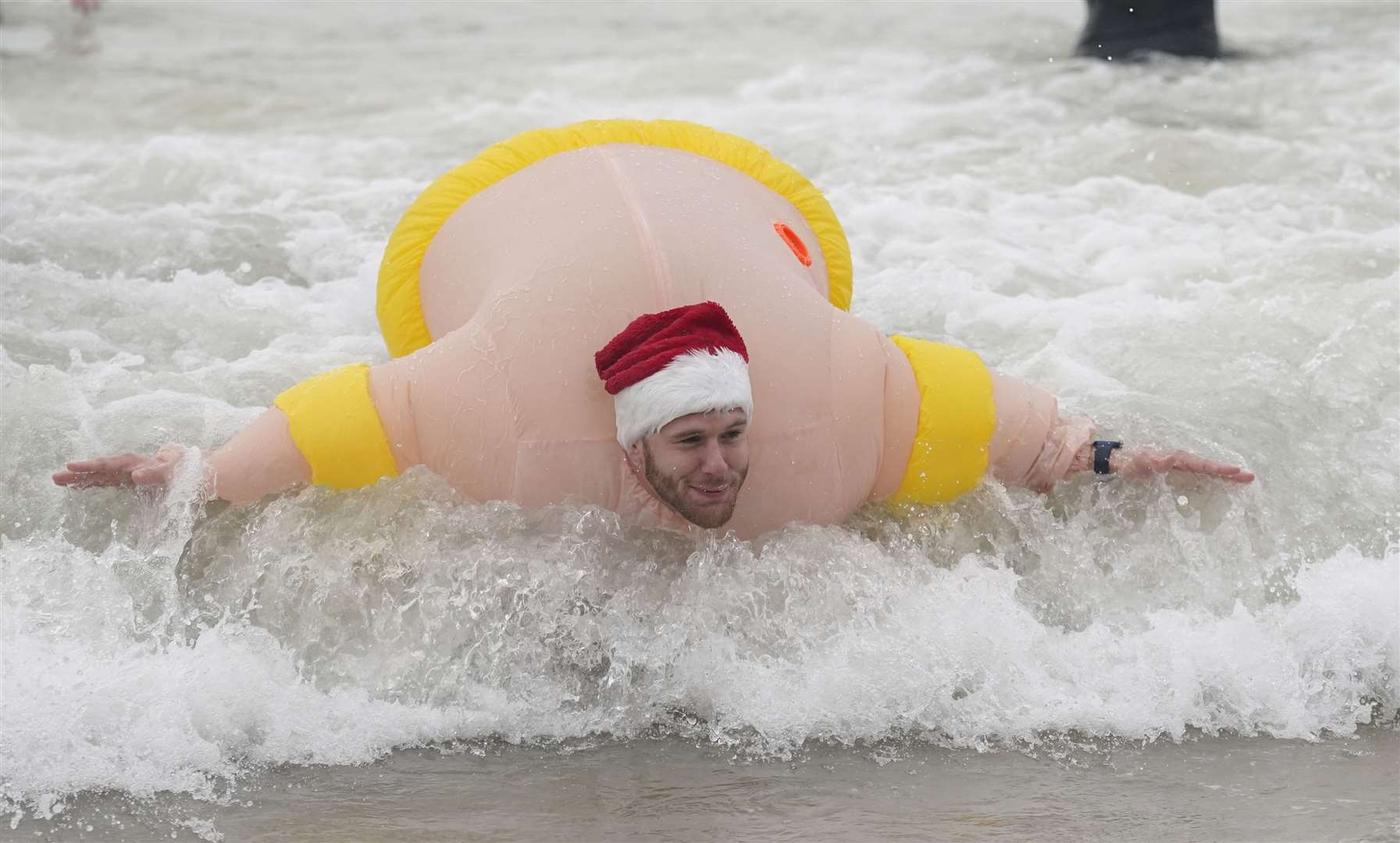 One cold-water fan combined a flotation device with his chosen costume (Andrew Matthews/PA)