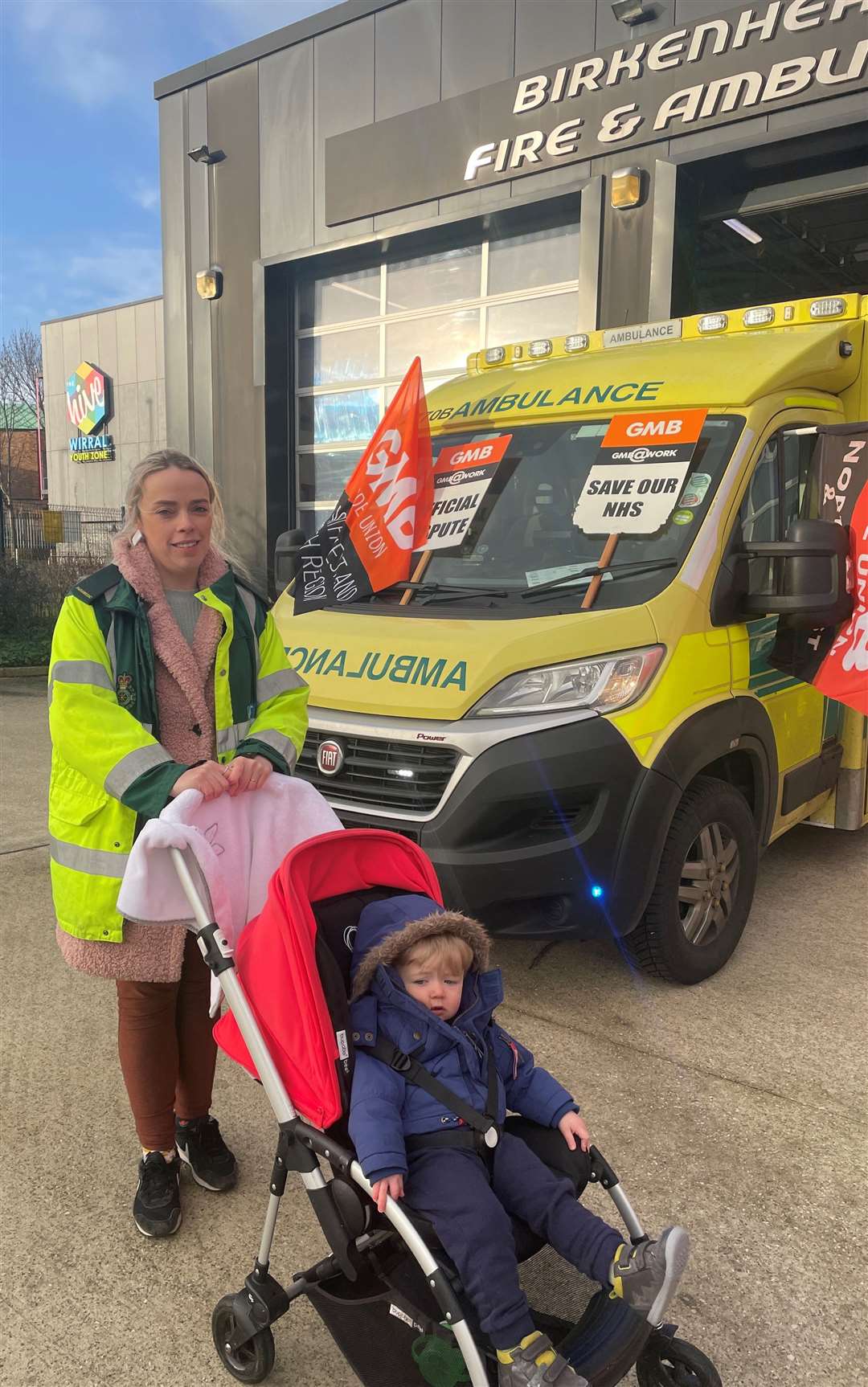 Paramedic Jenny Giblin and her 16-month-old son James Evans on the picket line in Birkenhead (Eleanor Barlow/PA)