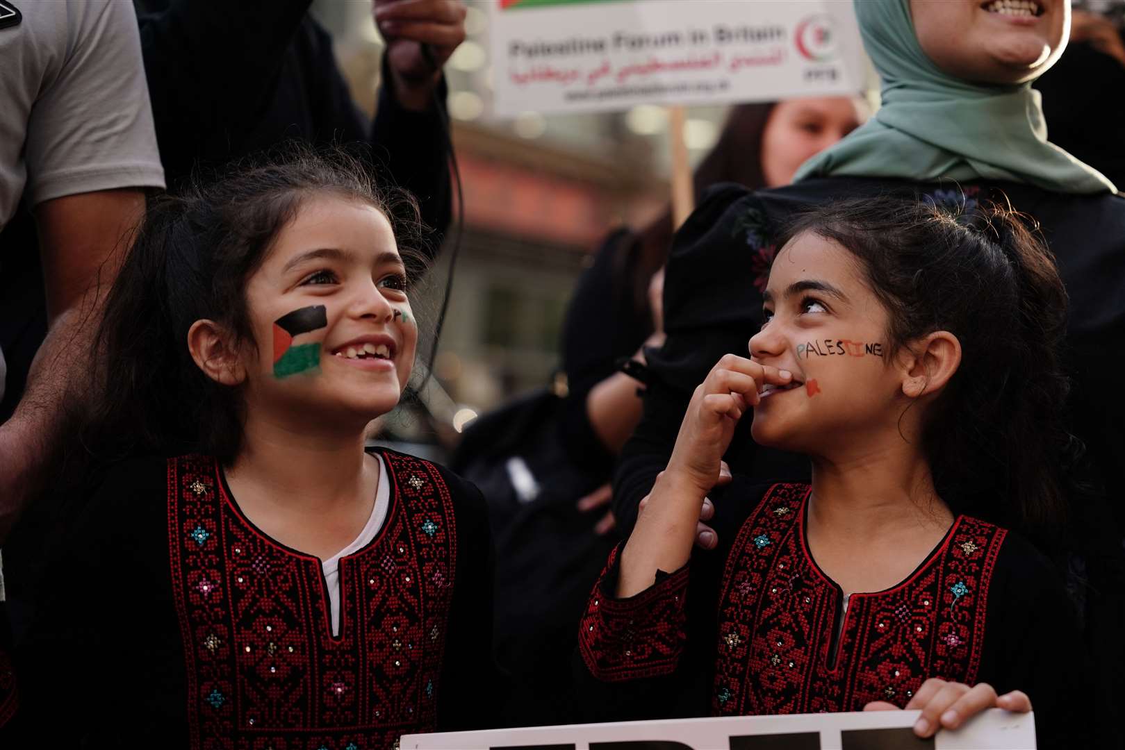 People take part in a Palestine Solidarity Campaign demonstration near the Israeli Embassy, in London (PA)