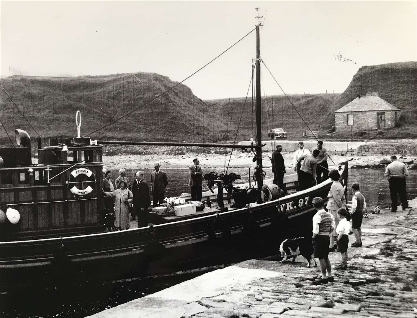 The Queen Mother sets out for Stroma along with all her picnic hampers on board the Primula from Harrow harbour, just down from her home at the Castle of Mey. Pictured with the Queen Mother (from left) are Commander and Lady Vyner, Thurso provost John Sinclair, two security officers, Malcolm Simpson, Eric Shaw, Billy (Borax) Mackay (back to camera), Alex Thompson and skipper Angus Macintosh on the quayside.