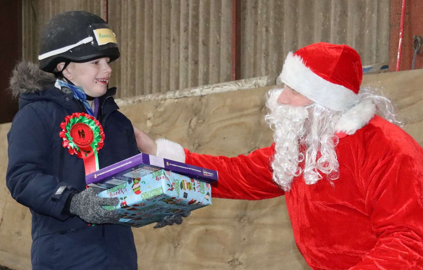 Ronnie Dickson gets his gifts from Santa. Picture: Neil Buchan