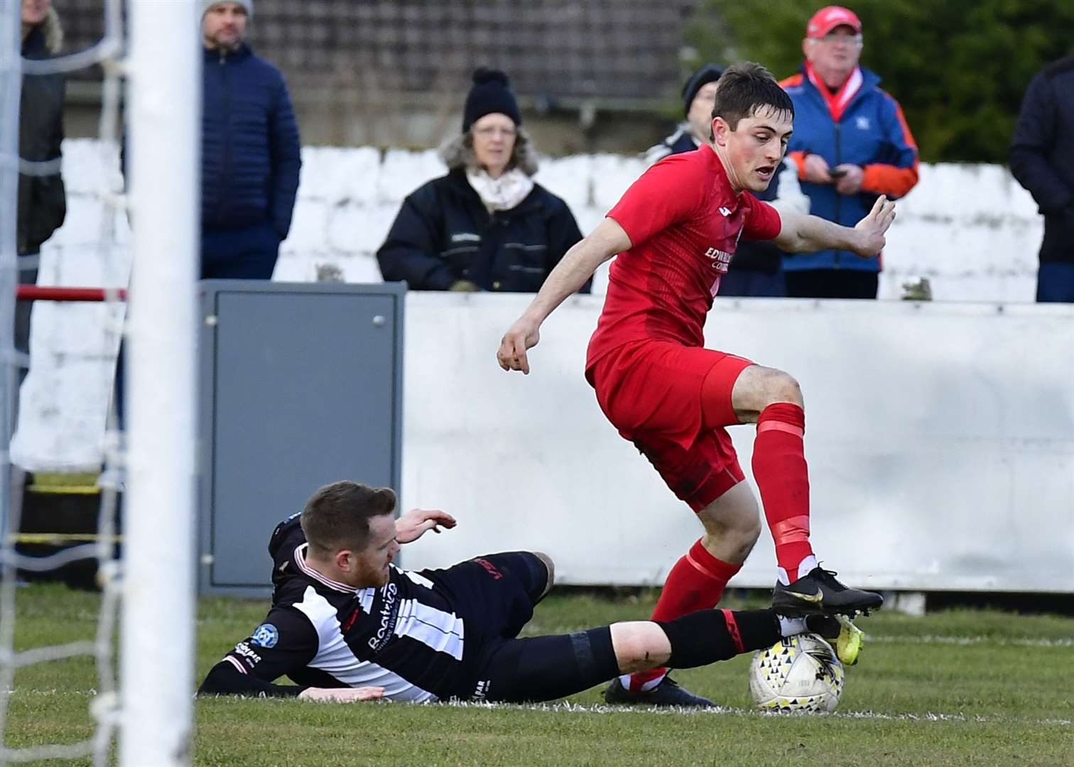 Wick Academy's Craig Gunn tackles John Pickles of Brora during the north derby at Dudgeon Park. Picture: Mel Roger