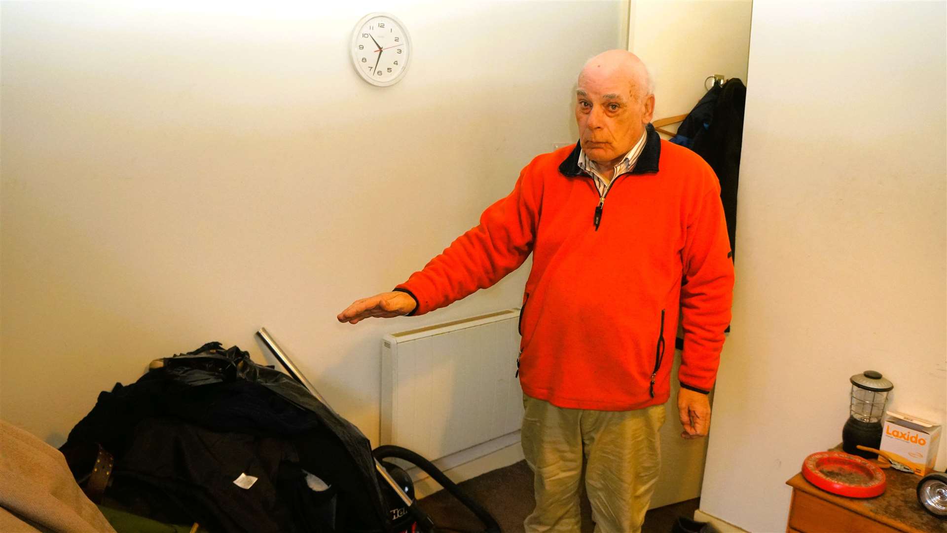 Charlie points to a pile of clothes affected by damp that he intends to throw out along with many of his other possessions. Picture: DGS