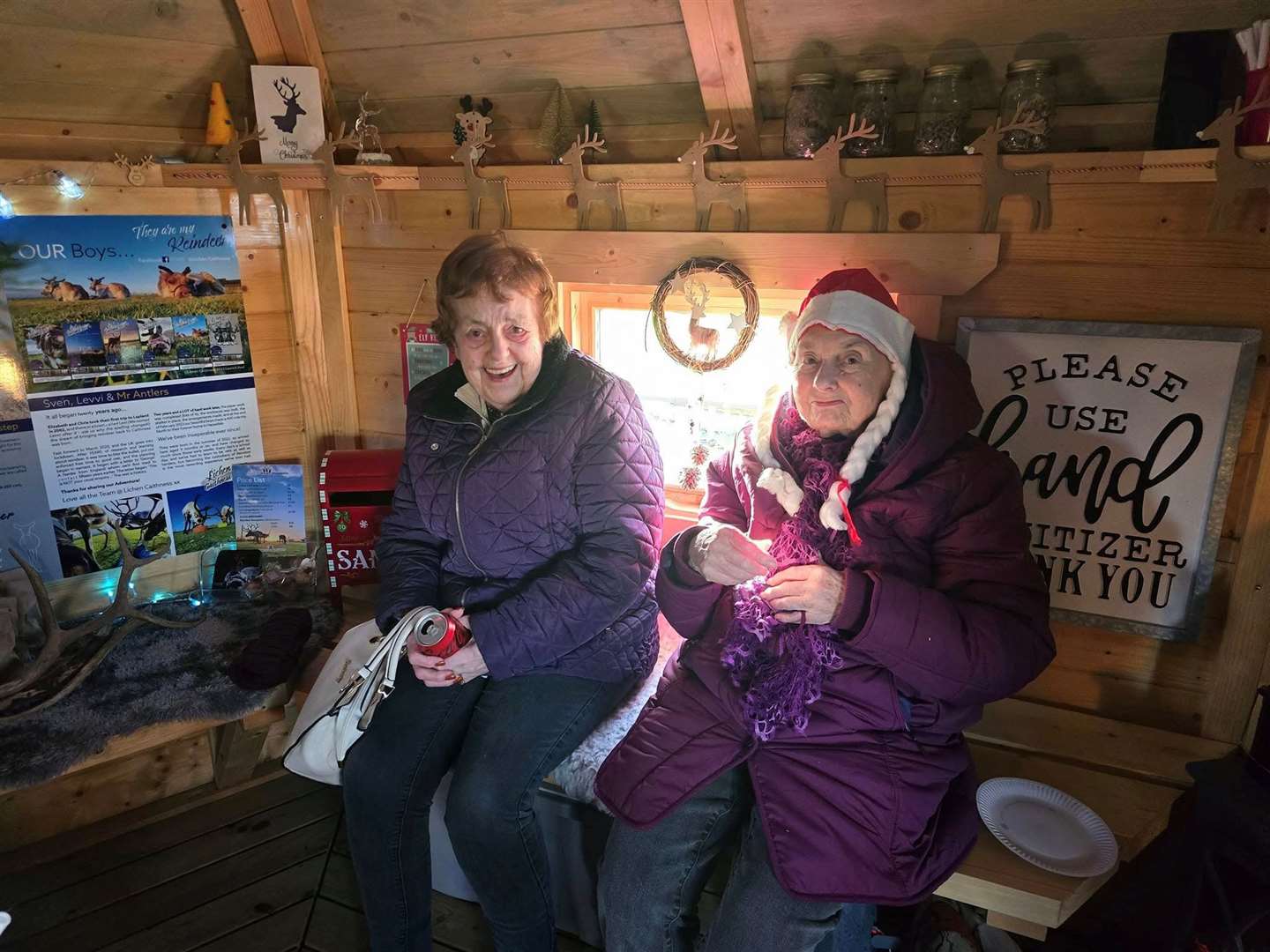 Pentland View residents Nancy MacAlpine and Isabella Trueman warm up in the festively decorated hut.