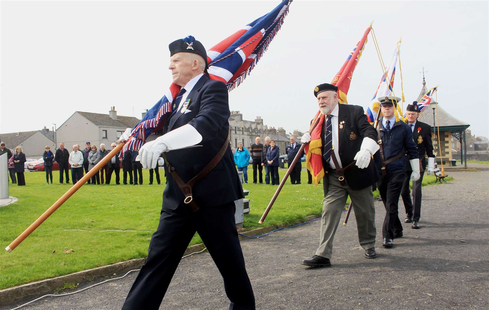 Alex Paterson, of the Wick, Canisbay and Latheron branch of the Royal British Legion Scotland, and Mike Coupland, of the Caithness branch of the Merchant Navy Association, leading the colour party to the Seafarers Memorial. Picture: Alan Hendry