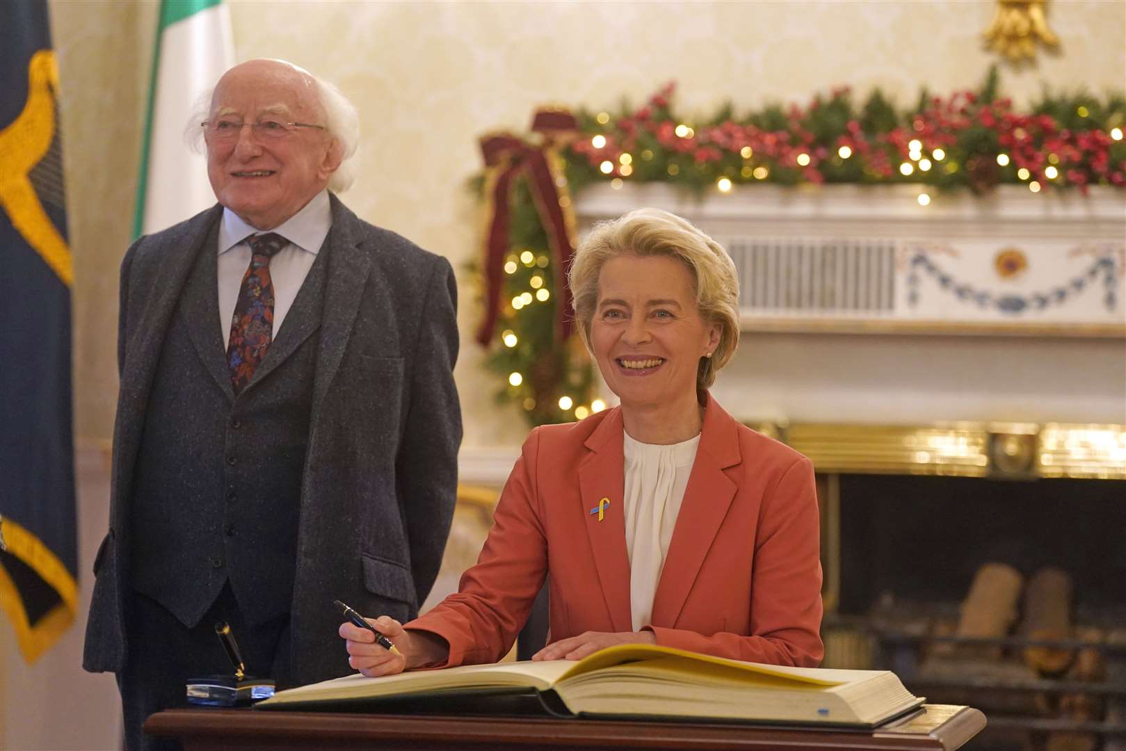 European Commission President Ursula von der Leyen signs the distinguished guests book as she meets President Michael D Higgins at Houses of Oireachtas in Dublin in 2022 (PA)