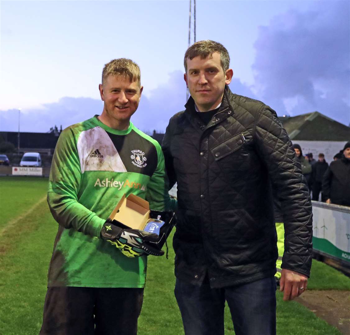 Thurso goalkeeper Asa Sinclair receiving the man-of-the-match award from North Caledonian League secretary Sandy Stephen. Picture: James Gunn