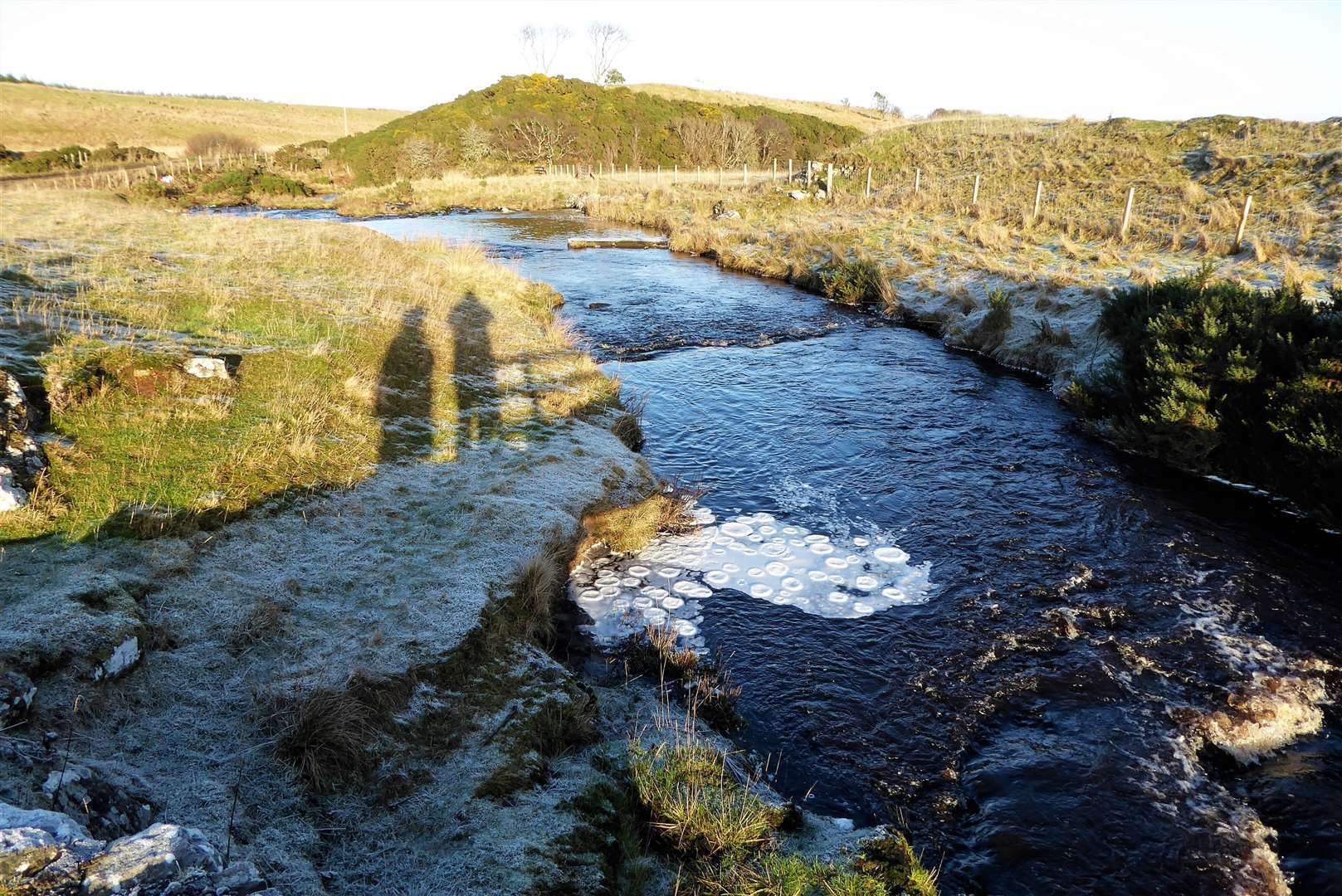 Ice pancakes at Scouthal Burn. Cuckoo Hill is in the background and the remains of an ancient monastery and cemetery known as the Clow Chapel is on the right hand side.