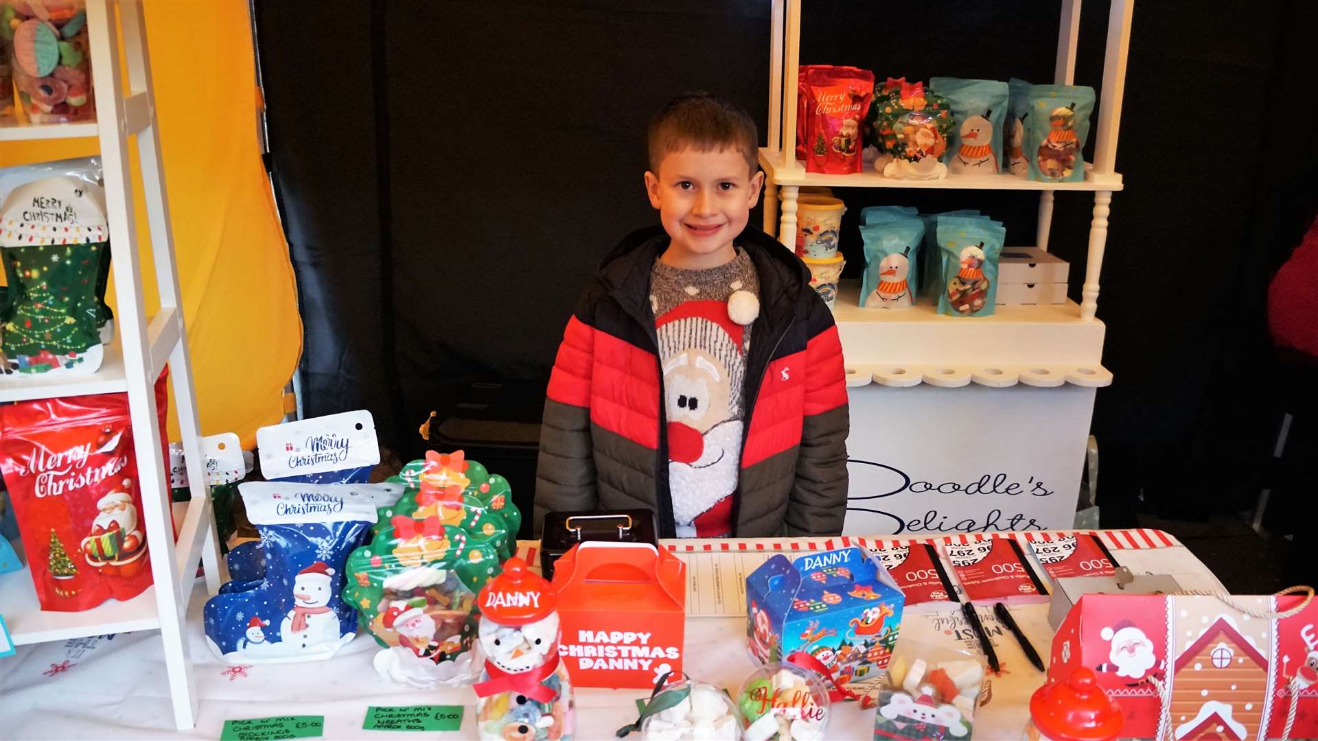 Danny Gow was manning a sweetie stall. The eight-year-old said he likes Christmas because he gets lots of toys. Picture: DGS