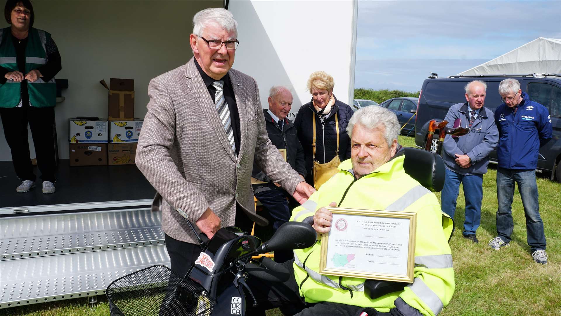 David Green receiving his honorary membership certificate from Iain Sutherland on behalf of Caithness and Sutherland Vintage and Classic Vehicle Club at this year's rally in John O'Groats. Picture: DGS