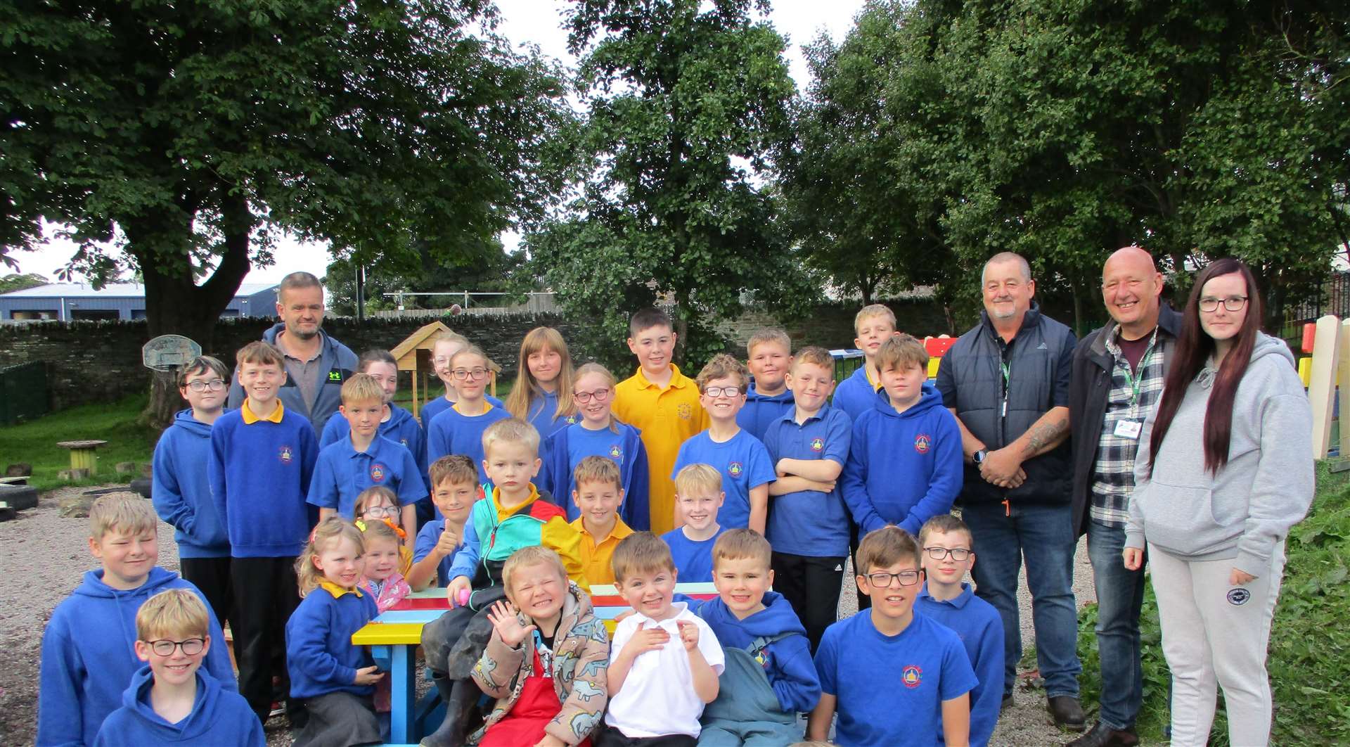 The pupils and ELC children joined by the community payback team with the new bench in the ELC garden.
