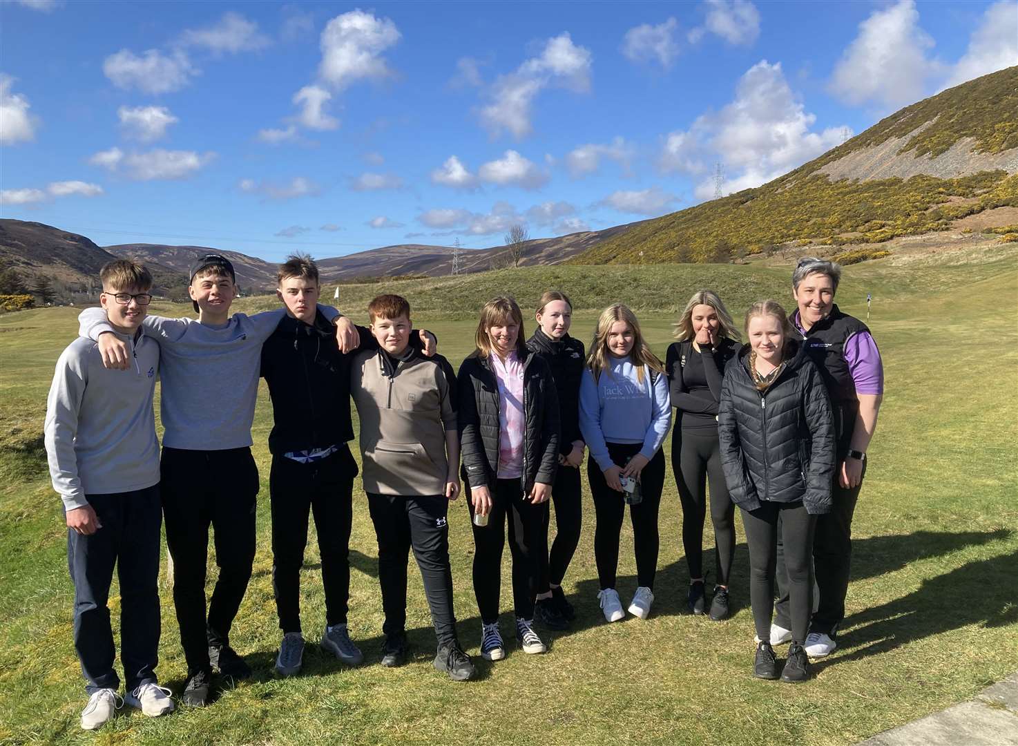 The nine junior golfers from Caithness at the Helmsdale course with Lesley Mackay, a pro who lectures at the Dornoch campus of UHI North Highland.