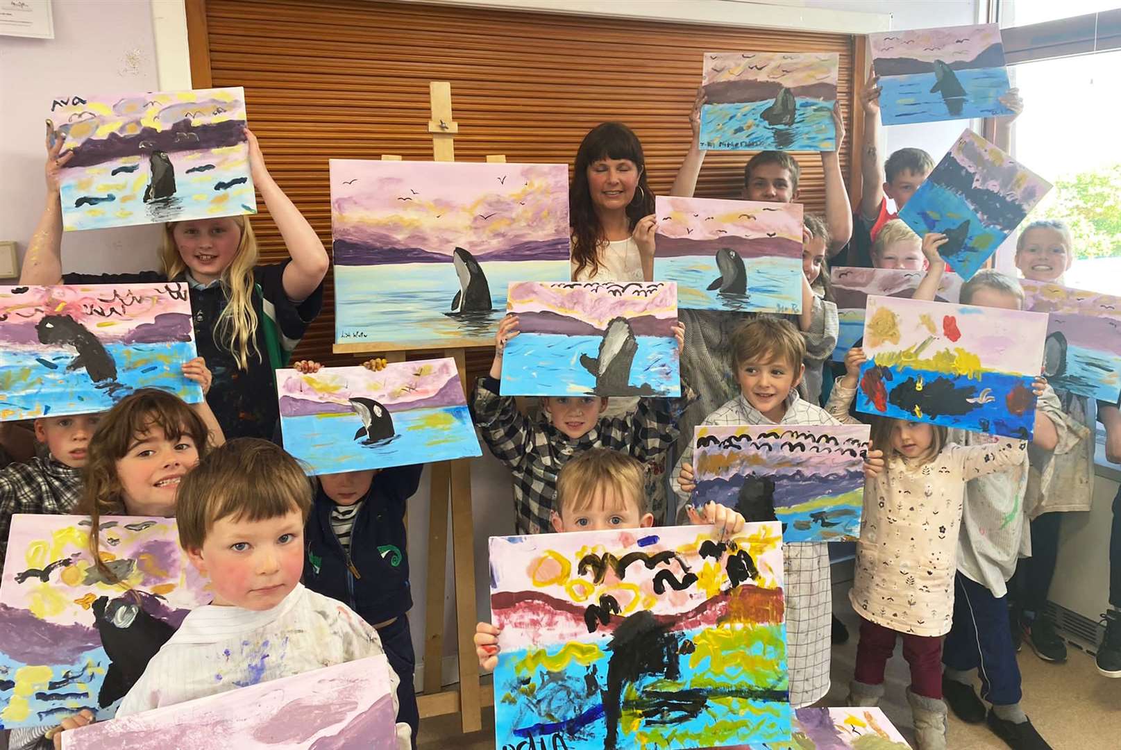The pupils show off their canvases with Lisa.
