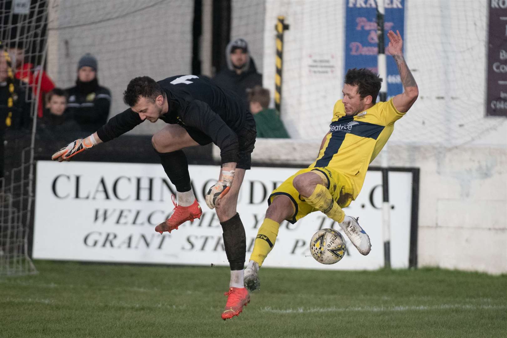 Clach keeper Martin Mackinnon and Wick midfielder Jack Henry in mid-air. Picture: Callum Mackay