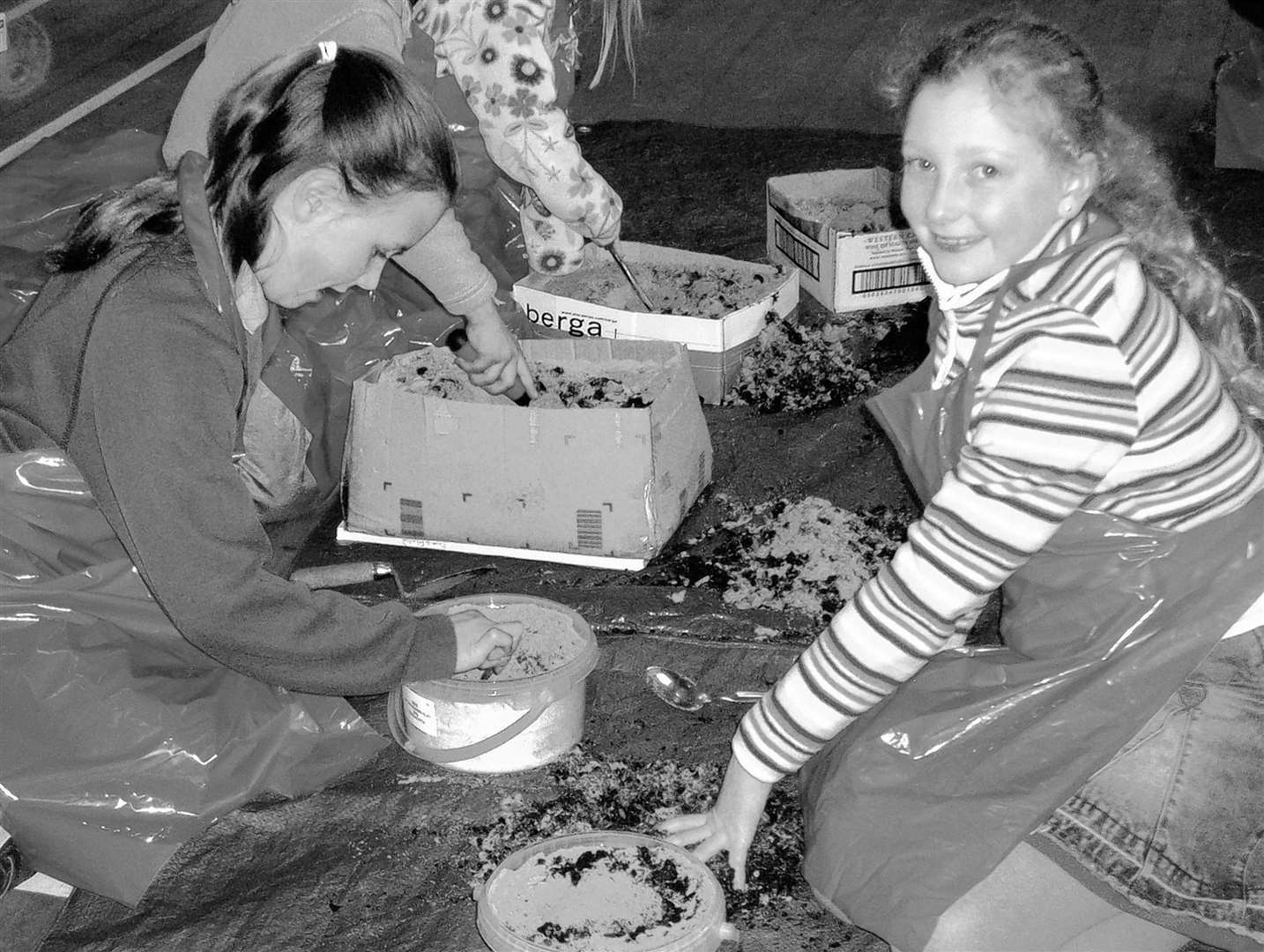 Two of the Caithness Young Archaeologists at a session Dunnet in 2006, learning how to excavate the postholes of a hut circle.