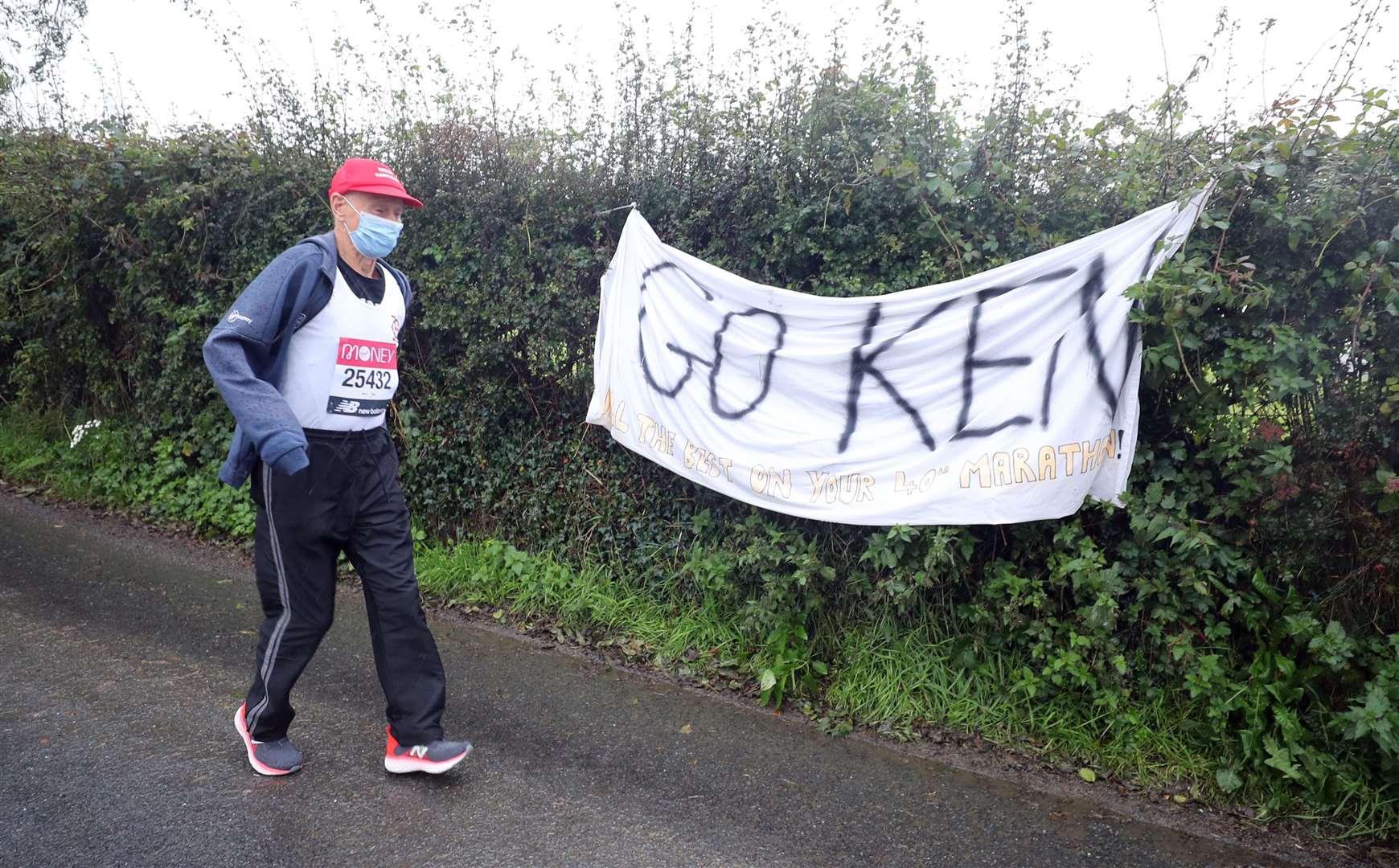 Ken Jones, 87, takes part in the historic first virtual London Marathon during gale-force winds and rain in his home town of Strabane, west Tyrone (Niall Carson/PA)