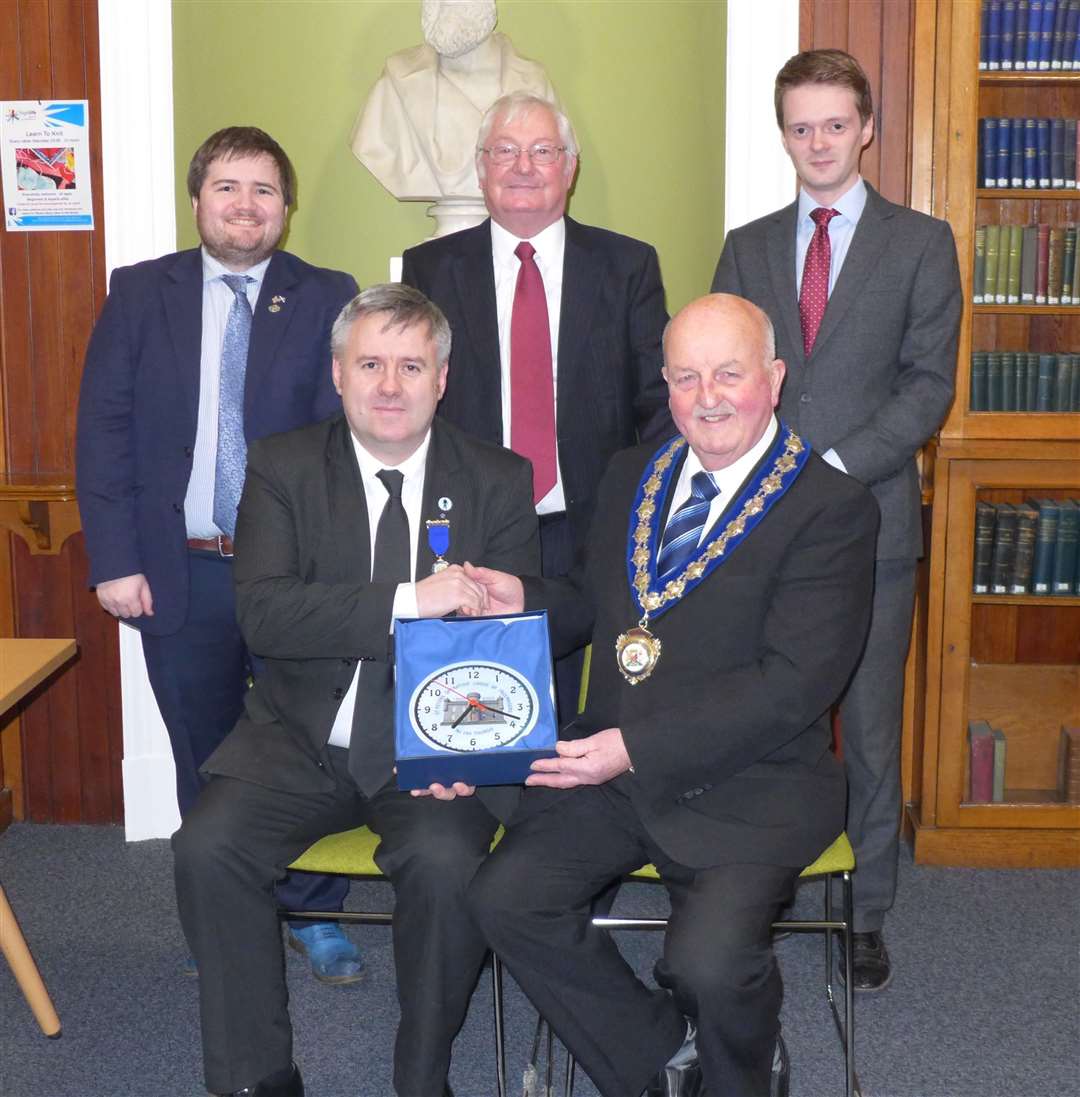 Right Worshipful Master William Durrand (left) presents civic leader Willie Mackay with a specially commissioned engraved wall clock which will be displayed at Caithness House in Wick. Looking on are Caithness councillors (from left) Struan Mackie, Donnie Mackay and Andrew Sinclair. Picture: Willie Mackay