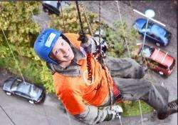 Annette Ward smiles for the camera as she abseils down from the rail bridge.