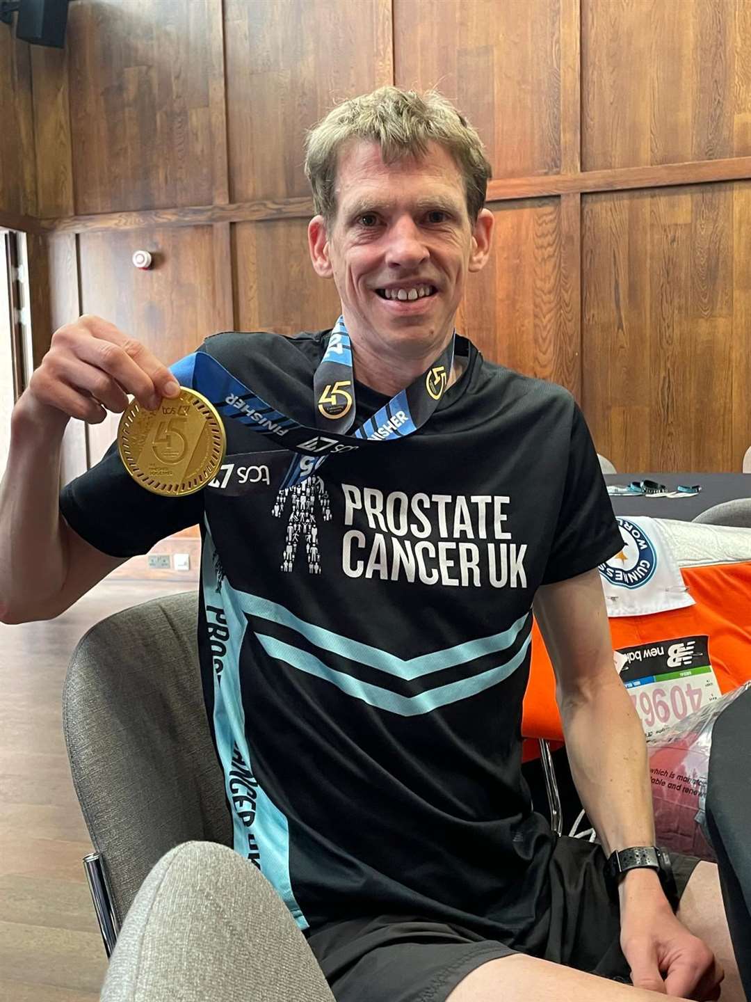 Michael Wiggins, the world’s fastest marathon runner dressed as a traffic cone, with his London Marathon medal (Michael Wiggins/PA)