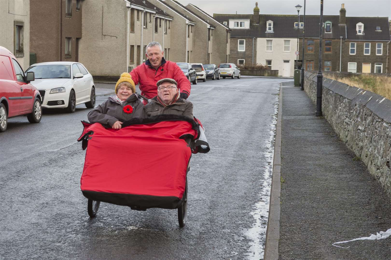 George Ewing takes Iain Sutherland and his daughter Helen Hill for a ride in the Wick Wheelers' rickshaw-style bike. Picture: Robert MacDonald / Northern Studios
