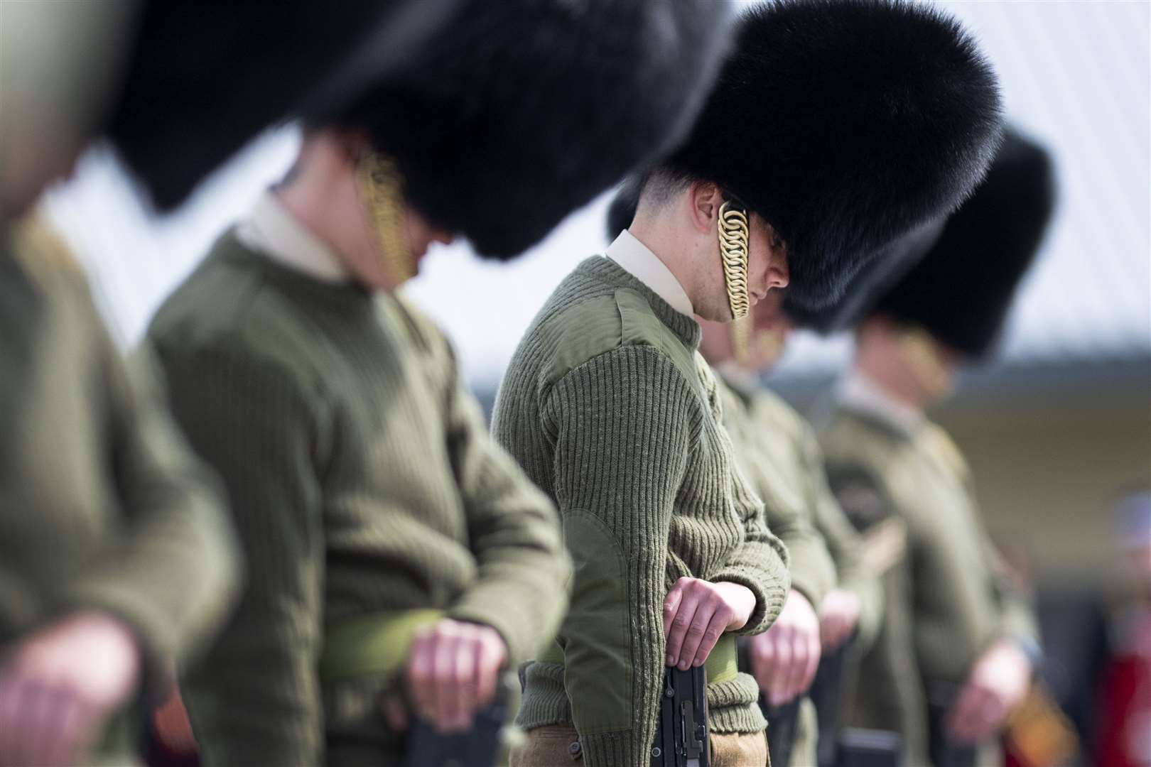 Soldiers from the Welsh Guards bow their heads as they rehearse for the funeral (Victoria Jones/PA)