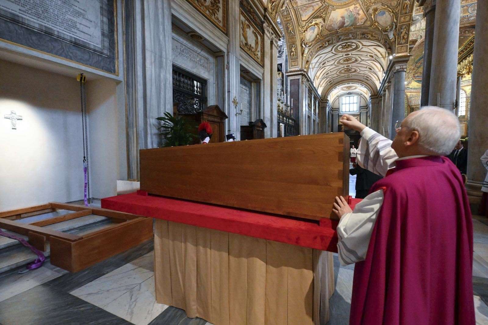 The head of the papal household Monsignor Leonardo Sapienza puts a seal on the coffin containing the body of Pope Francis during the burial ceremony in St Mary Major Basilica in Rome (Vatican Media via AP)