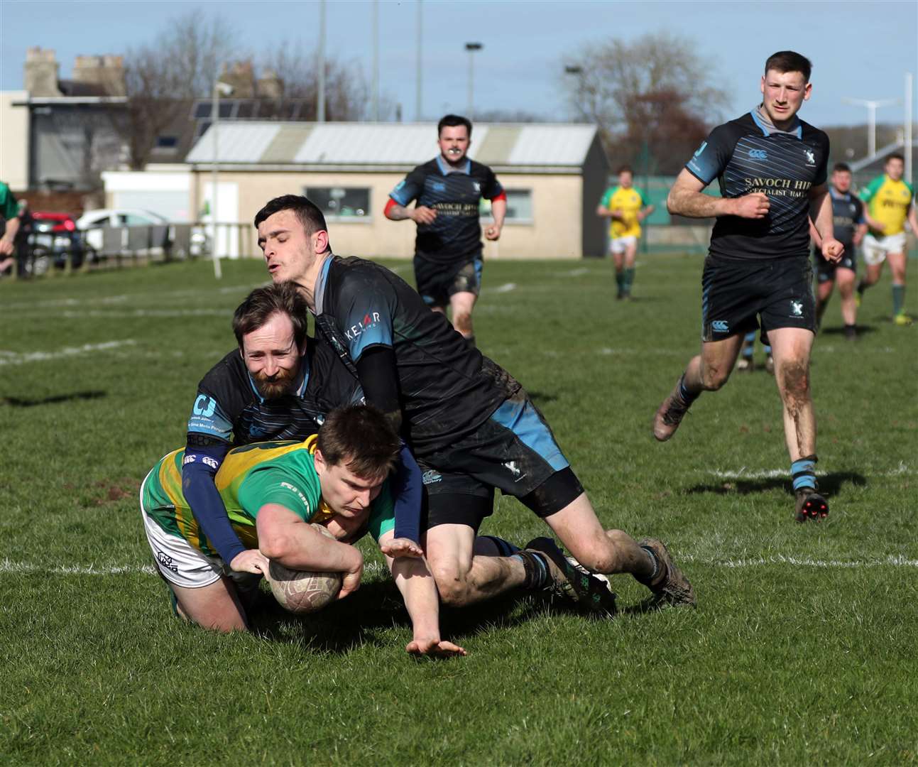 Stuart Crichton scores a try despite the efforts of two defenders during the Yellows' recent 48-22 victory over Fraserburgh at Millbank. Picture: James Gunn