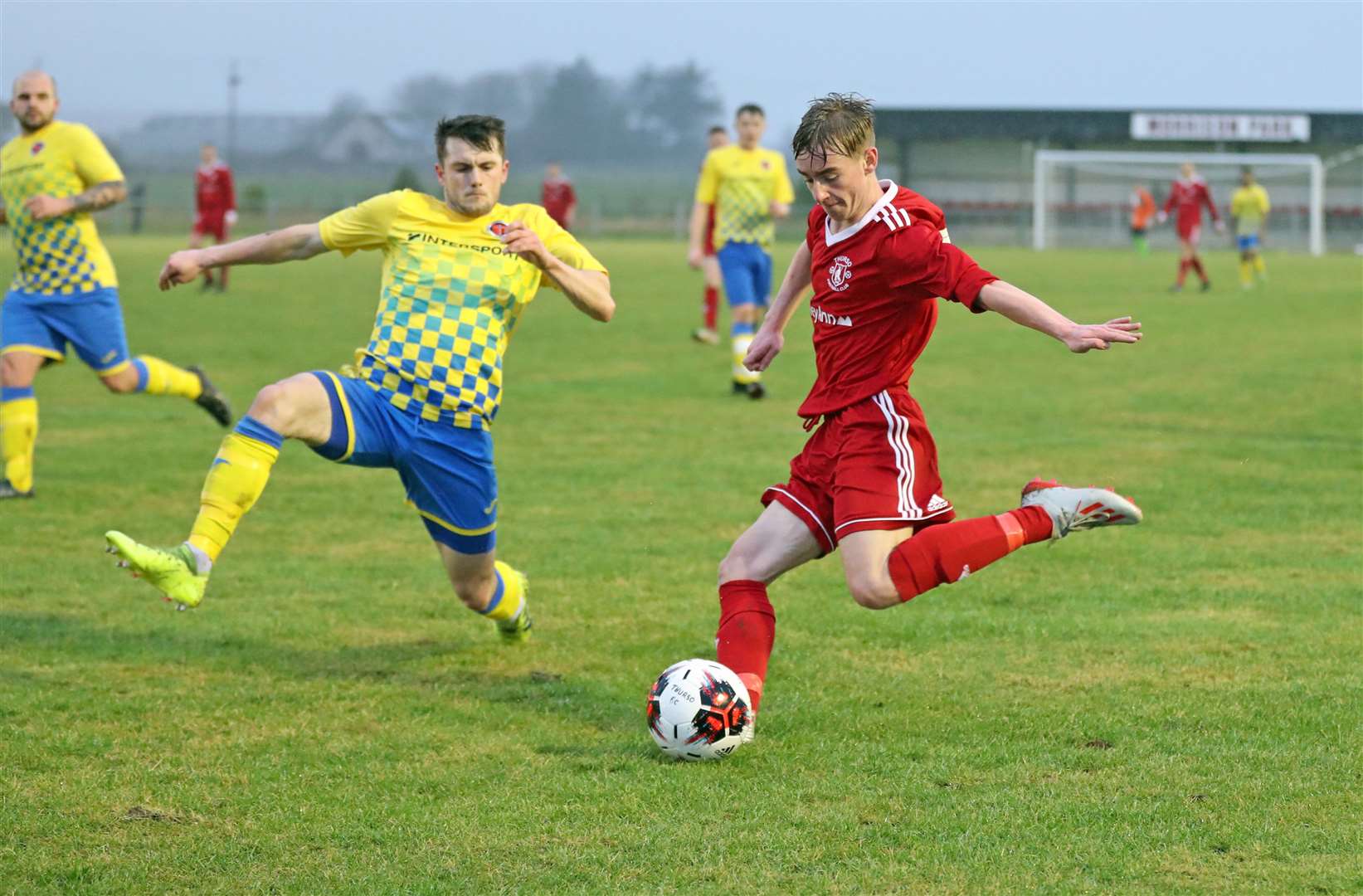 Thurso's Cameron Montgomery prepares to fire a cross past Steven Hellewell of Orkney. Picture: James Gunn