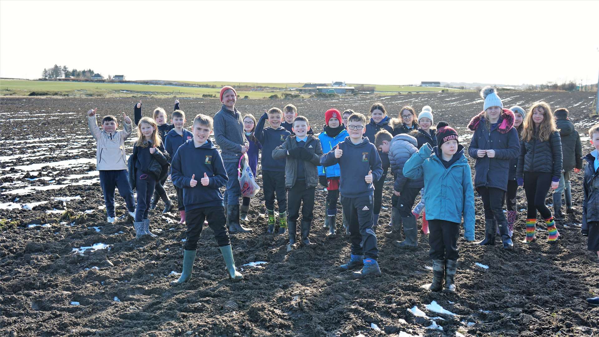 The children search in a muddy field beside Loch Watten to find the site of the wizard's grave. Picture: DGS