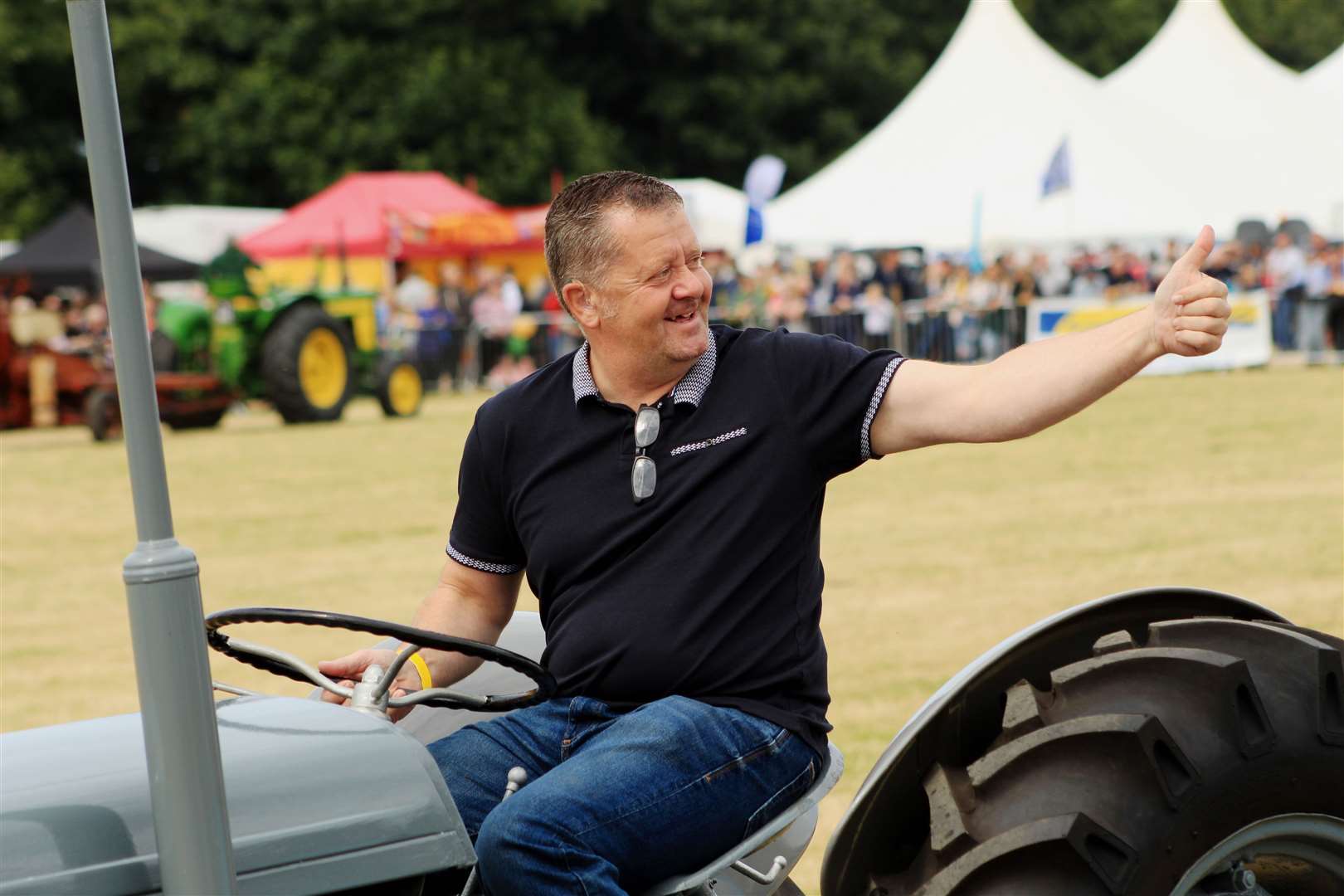 Thumbs-up for the County Show vintage tractor parade. Picture: Alan Hendry