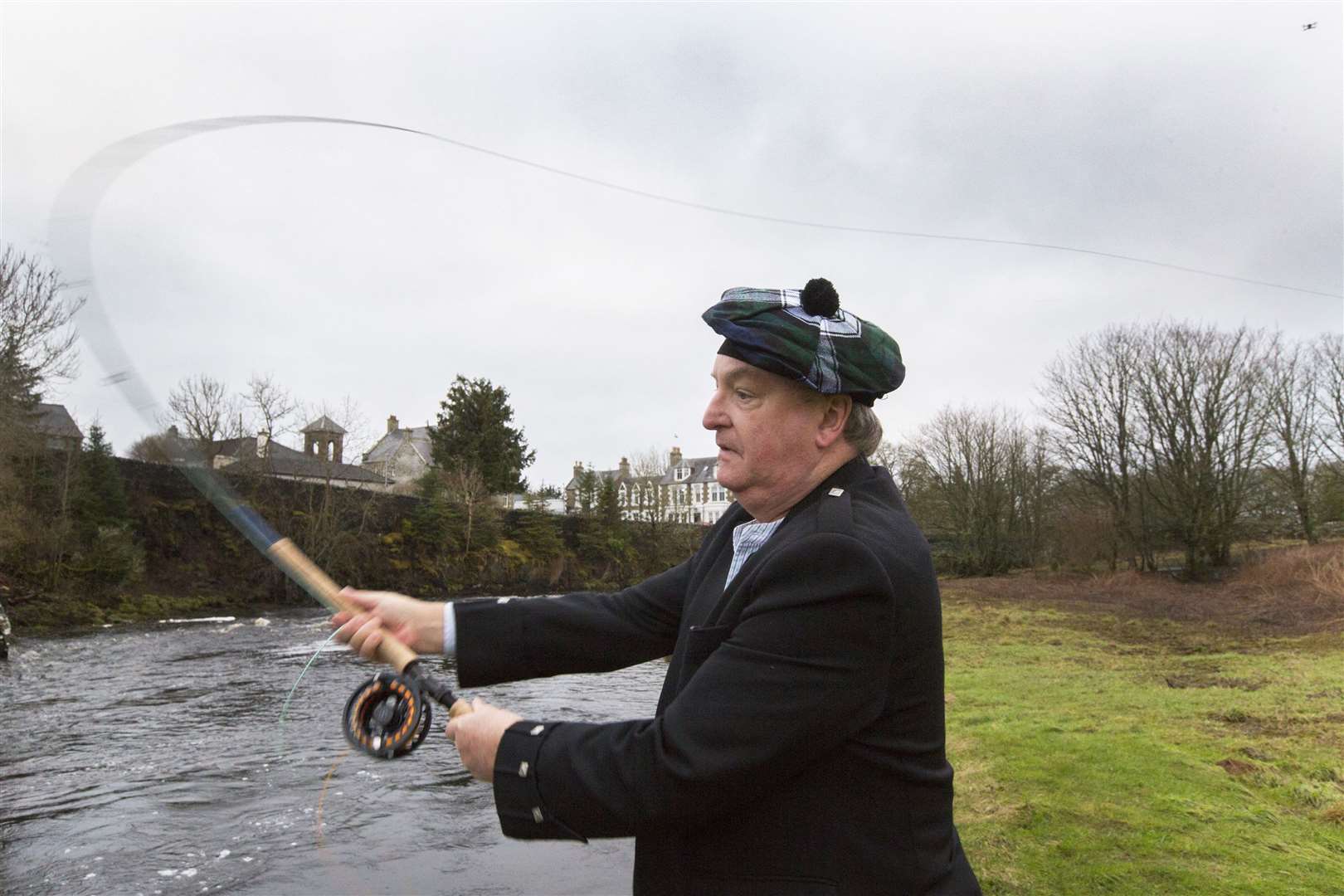 John Graham, of Washington DC, casting the first fly to open the 2024 salmon season. This is his 46th year of fishing on the River Thurso. Picture: Robert MacDonald / Northern Studios