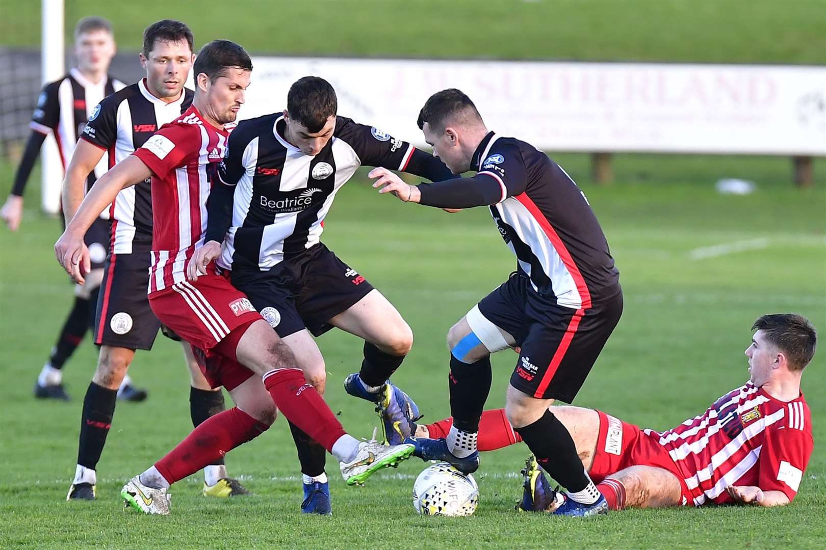 Wick Academy's Gordon MacNab gets his foot on the ball during a scramble for possession. Picture: Mel Roger