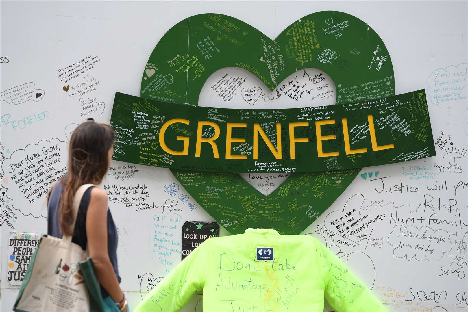 People at the Grenfell Memorial Community Mosaic at the base of the tower block in London on the third anniversary of the Grenfell Tower fire which claimed 72 lives on June 14 2017 (Kirsty O’Connor/PA)