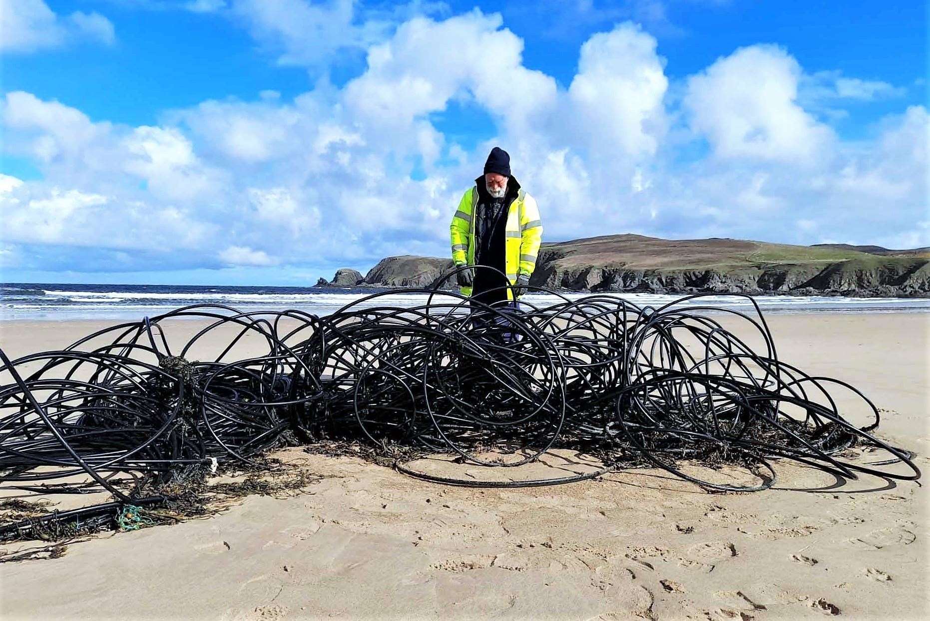 Allan Sinclair recovering a large amount of co-axial cable from the sea on the Caithness coast.