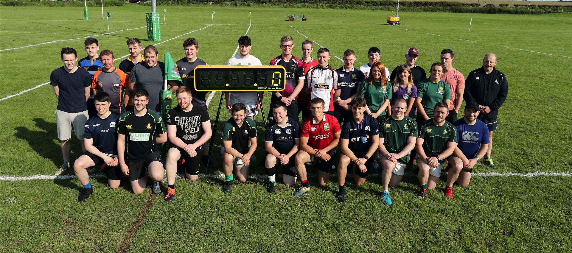 The squad of players line up alongside the electronic clock just before the start of the bid to set a Guinness World Record for touch rugby. Picture: James Gunn