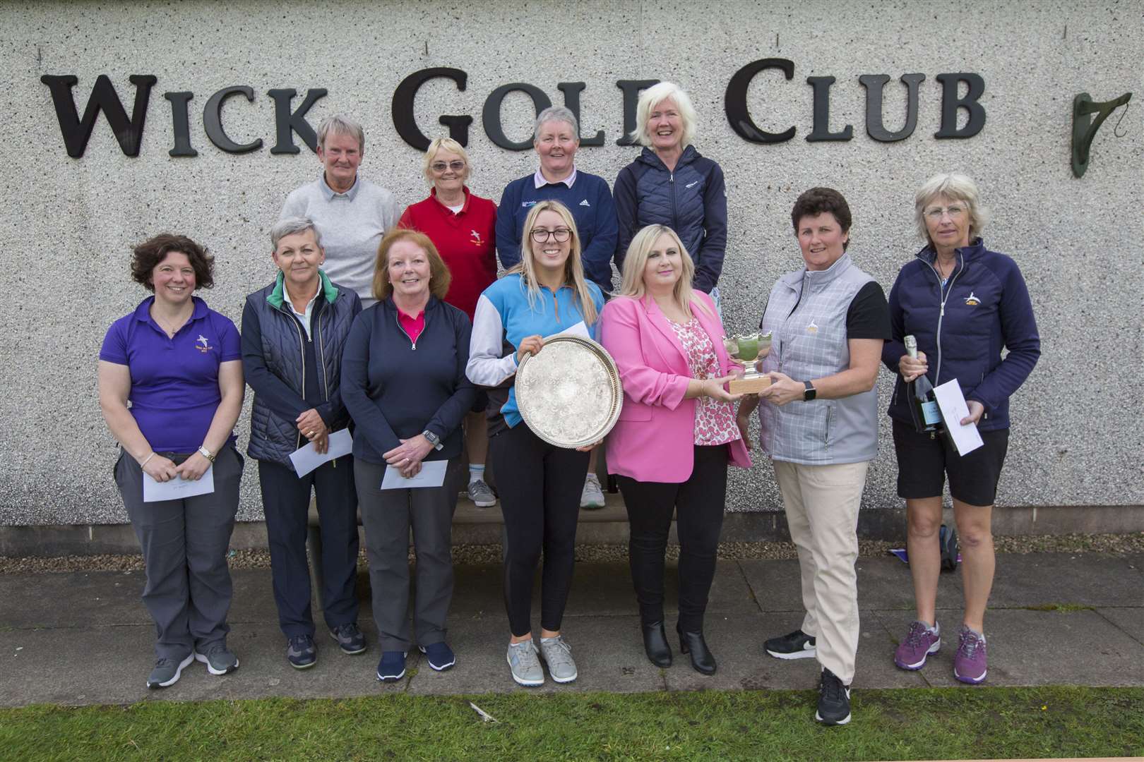The scratch trophy for the Wick Golf Club's ladies open competition went to a player from the home club when Dee MacAngus (front right) won the award which she received from sponsor Yvonne Fitzgerald of Yvonne Fitzgerald Properties.The handicap trophy went to Emma Durrand of Thurso Gold Club (front centre). Looking on are some of the other prize winners in the competition which was played on Saturday.Picture: Robert MacDonald/Northern Studios