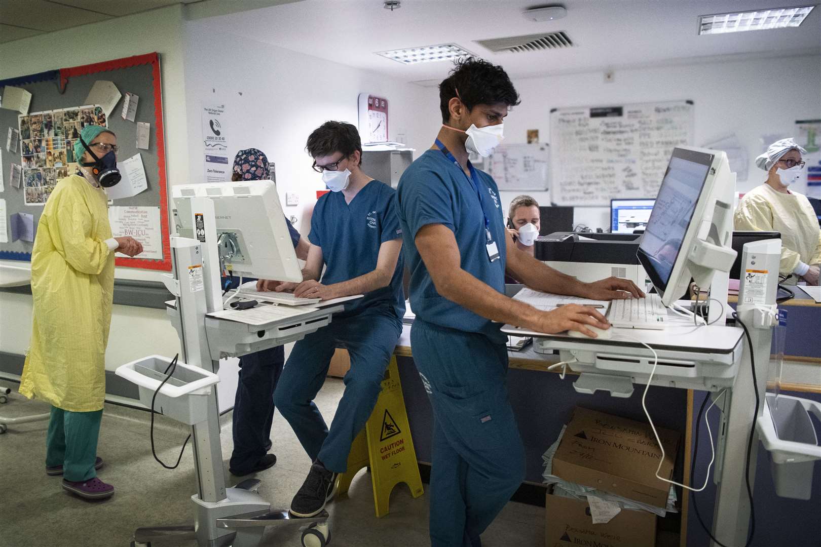 Staff members work at a desk in the ICU (Victoria Jones/PA)