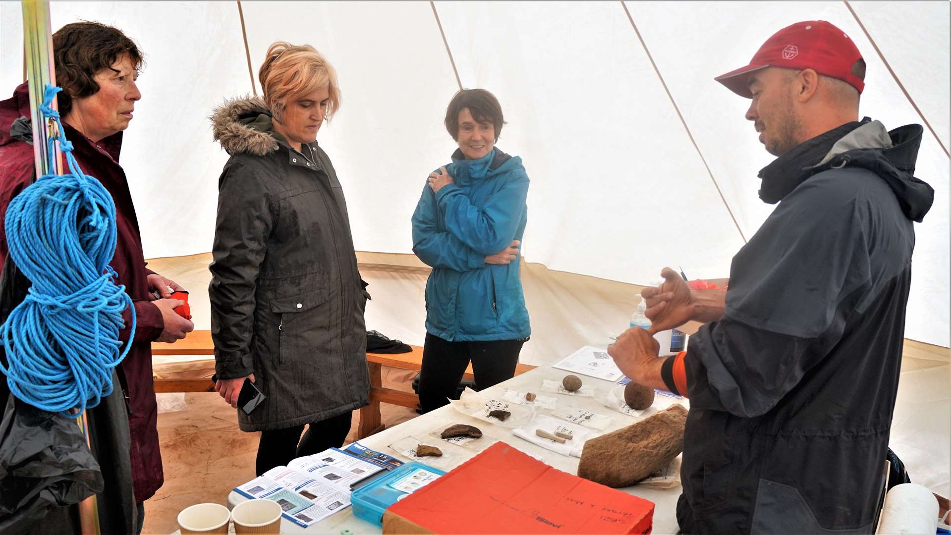 Rick Barton, project officer at the dig, shows some of the items recovered to members of the public at the open day event last year.