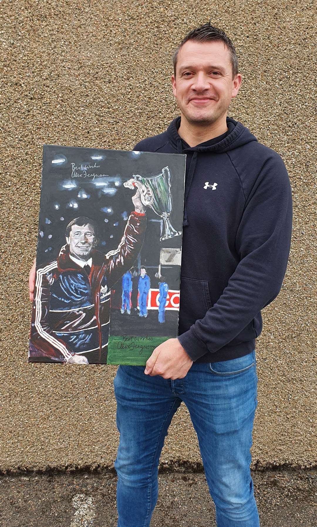 Davie Greig with his painting of Sir Alex Ferguson, signed by the football legend. Davie's football portraits have raised thousands of pounds for charities.
