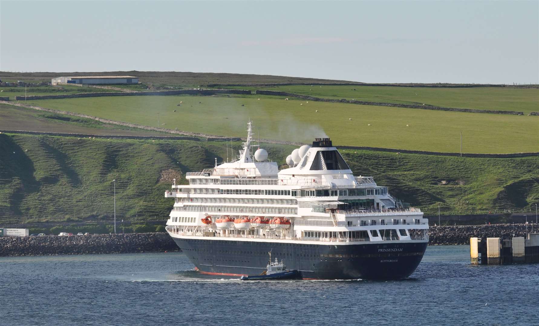 The cruise ship Prinsendam getting a helping hand leaving her berth at Scrabster during the summer. Picture: Hugh Millar
