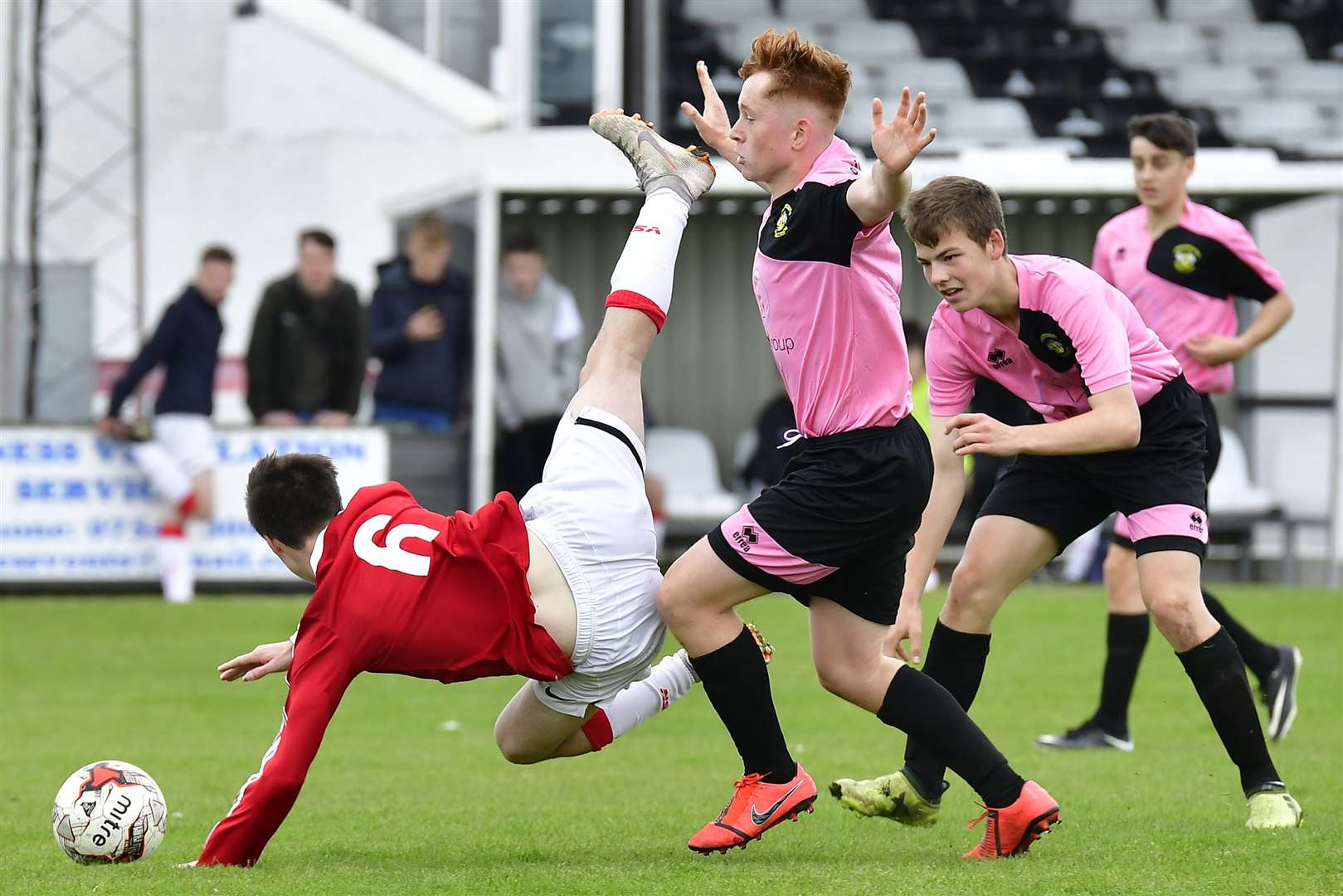 Scott Macdonald of Wick Academy U17s is upended by Clach's Aidan Mackinnon during a 2-2 draw at Harmsworth Park in September. Picture: Mel Roger