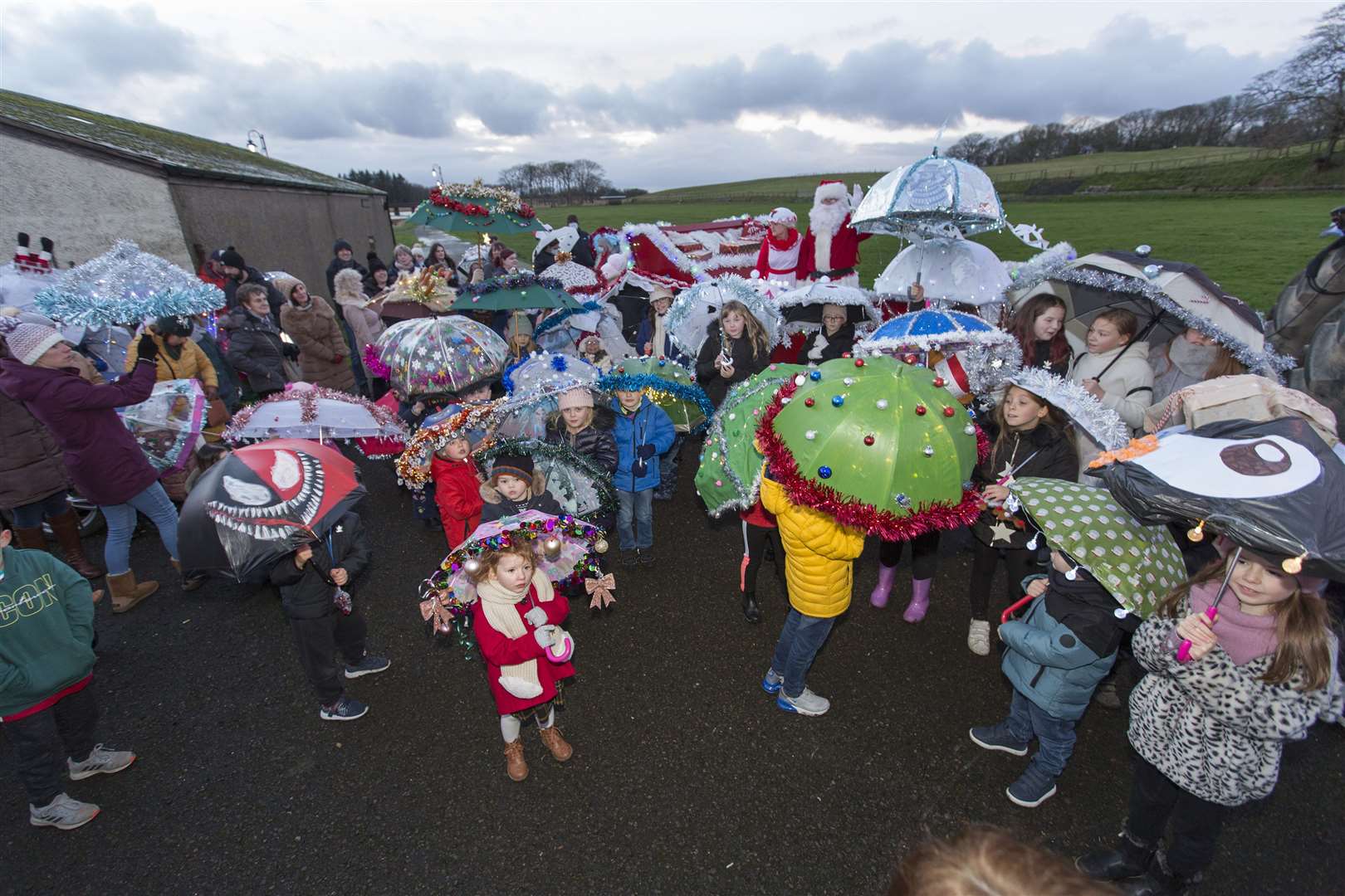A sea of brollies gather round Santa's sleigh before the umbrella parade sets off from the riverside to the town centre. Photo: Robert MacDonald/Northern Studios
