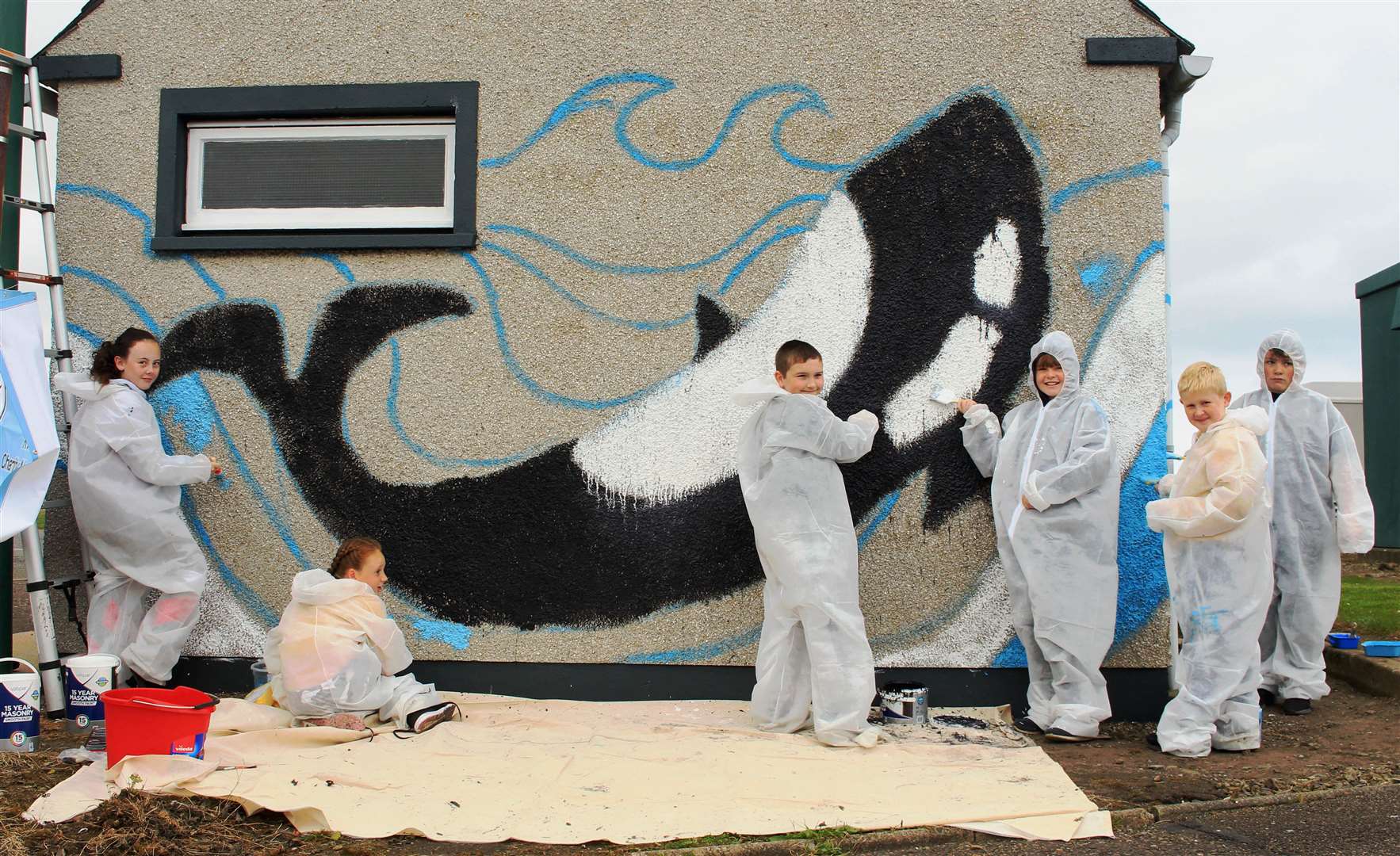 The mural well under way on Saturday afternoon, thanks to the efforts of sea cadets and youth club members.